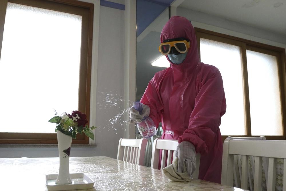 FILE - An employee of Pyongyang Dental Hygiene Products Factory disinfects the floor of a dinning room as the state increased measures to stop the spread of illness in Pyongyang, North Korea, May 16, 2022. A top official at the World Health Organization said the U.N. health agency assumes the coronavirus outbreak in North Korea is “getting worse, not better,” despite the secretive country's recent claims that COVID-19 is slowing there. (AP Photo/Cha Song Ho, file)
